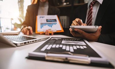 Team job. Photo young businessmans crew working with new startup project on desk at meeting room. 
