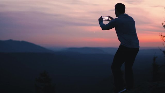 Silhouette Outline of Man Taking Smartphone Picture from Mountain Lookout