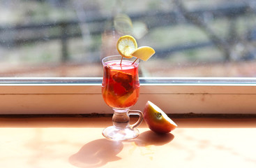 red cocktail with fruit in a glass