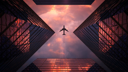 The plane flies over the skyscrapers. Wonderful composition with sunset