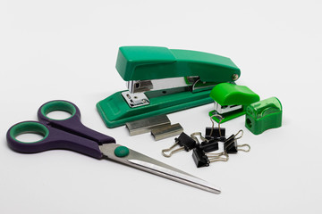 Plastic and metal staplers with staples, binder clips, scissors, pencil sharpener isolated on white...