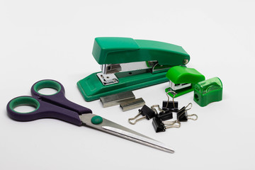 Plastic and metal staplers with staples, binder clips, scissors, pencil sharpener isolated on white...