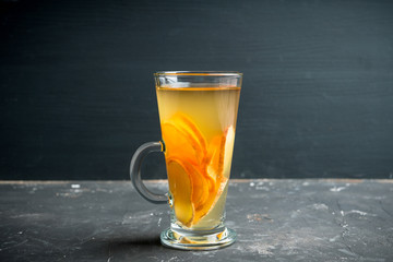 Healthy hot beverage with lemon, ginger and spices for protection in flu season. Selective focus. Shallow depth of field.