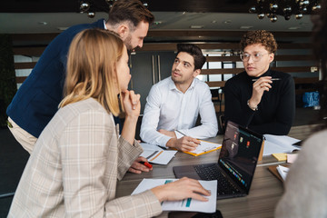 Group of smart motivated businesspeople working together