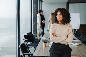 Beautiful young smart businesswoman standing