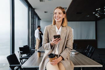 Beautiful young smart businesswoman standing