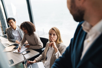 Group of smart motivated businesspeople working together