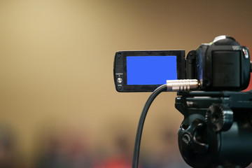 Camcorder with a blue background on the screen on a blurred background