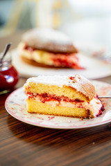 The Piece of Victoria Sponge Cake with Butter Cream and Strawberry Jam Filling