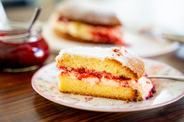 The Piece of Victoria Sponge Cake with Butter Cream and Strawberry Jam Filling