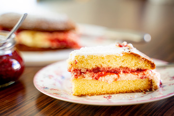 The Piece of Victoria Sponge Cake with Butter Cream and Strawberry Jam Filling