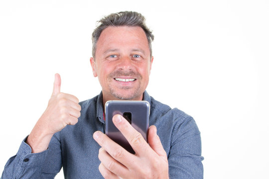 handsome man thumbs up looking screen phone smartphone happiness smile