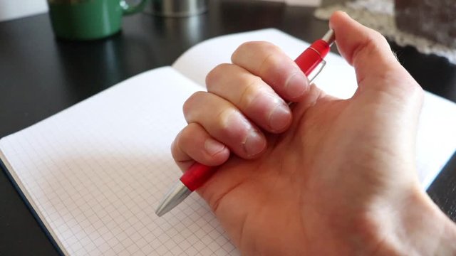 Pen clicking repeatedly and with a costant pattern and rythm. The rythmic way in which the button of the pen is pressed represents stress, boredom, impatience, ittiration or anxiety by a nervous man