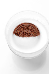 chocolate cookies with cream in a glass of milk