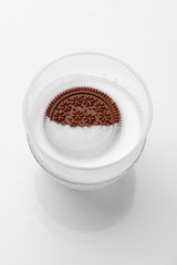 chocolate cookies with cream in a glass of milk