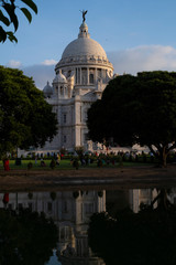 View of Victoria Memorial along with the nearby pond and the reflection.