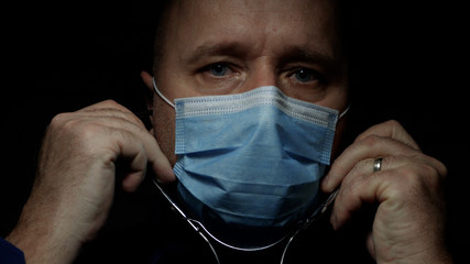 Doctor Wearing Protective Face Mask, Medical Person with Protection Equipment in a Quarantined Hospital Against COVID-19 Pandemic