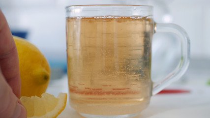 Fresh Sweet and Hot Cup with Tea and a Slice of Lemon at Breakfast Time in the Morning