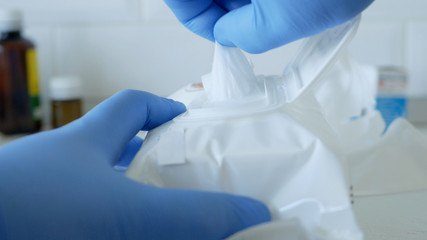 Social Distancing Lifestyle, Hands Protected with Gloves Taking Wet Wipes from a Package Used for Cleanliness