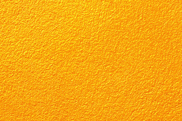 Gold or yellow paint on cement wall texture or backgrond