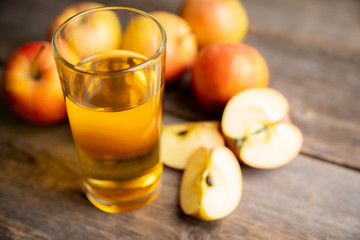 Apple juice with freshly harvested apples on the rustic background. Selective focus. Shallow depth of field.