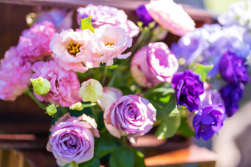 Bouquets of fresh flowers decoration of the festive table. Celebrating an open air party. Decor Details