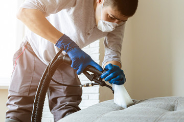 Man cleaning sofa chemical cleaning with professionally extraction method. Upholstered furniture....