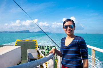 Close up portrait Happy thai woman enjoying the sea from ferry. summer, holidays, vacation, travel...