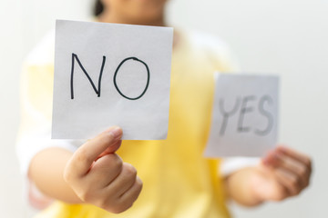 Girl holding paper with No