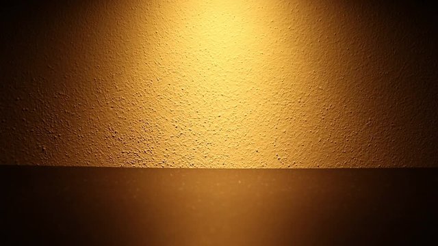 The effect of a dimmable light on a wall. The brightness of the light increases and decreases. The dimmer is set on a small led light