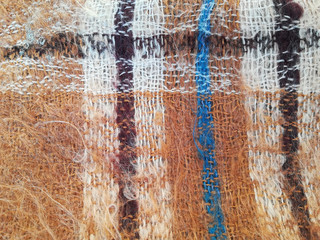 texture of woolen knitted scarf. checkered plaid, background, maher brown warm