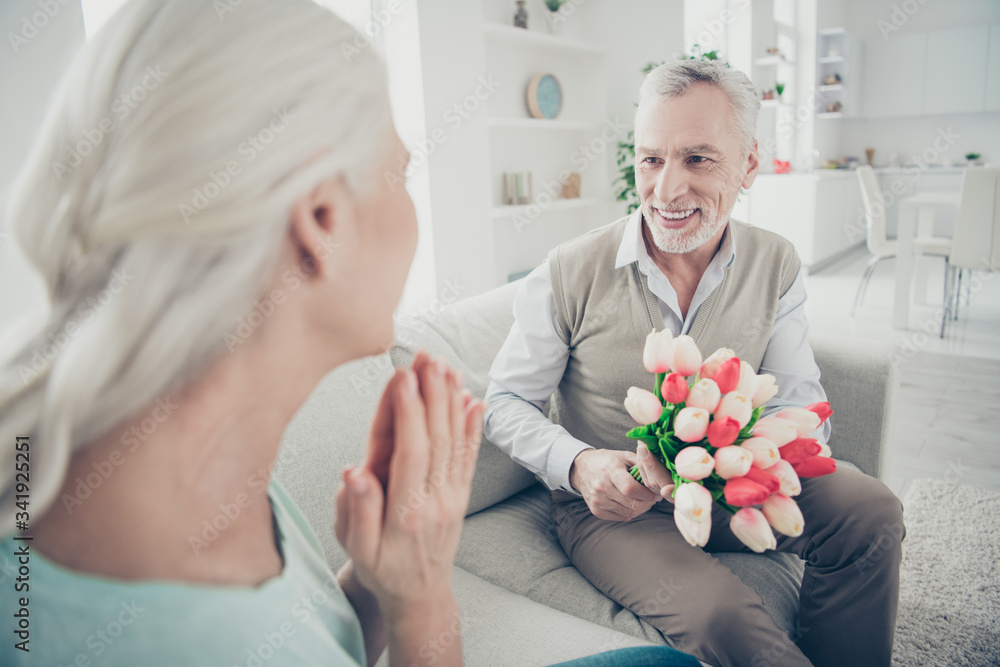 Sticker Rear view photo of two adorable aged people anniversary holiday giving big red tulips bunch sitting couch