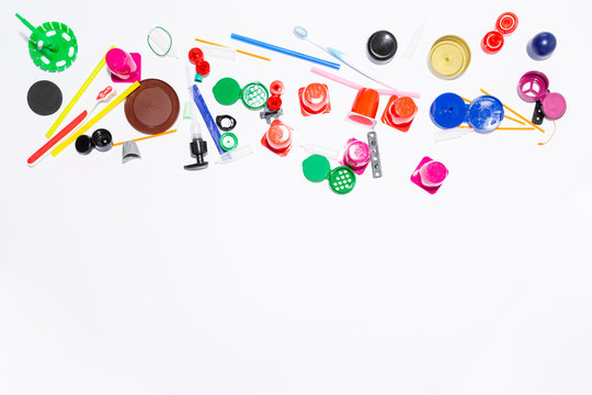 Assortment of obsolete plastic garbage items on white background