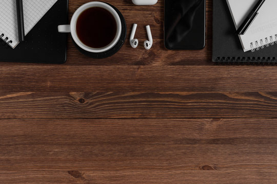 Notebook, graphics tablet, pencil and pen lie on a wooden brown table. Concept for designer or digital artist. Image with place for your text.