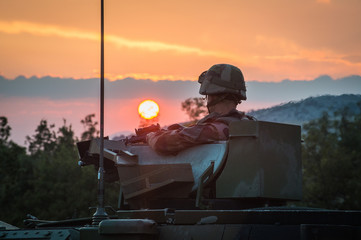 a soldier in a vehicle with sunset in the background during the preparation in the Canjuers camp of...