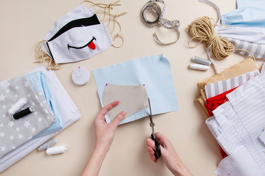 Sewing funny child anti-virus mask. Homemade mask with smile. DIY face mask for stay safe at pandemic or quarantine. Zero waste handmade Cotton natural kids mask against infection. Smile and stay safe - Powered by Adobe