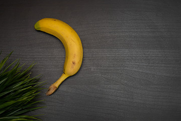fresh banana on dark wooden table representing healthy food