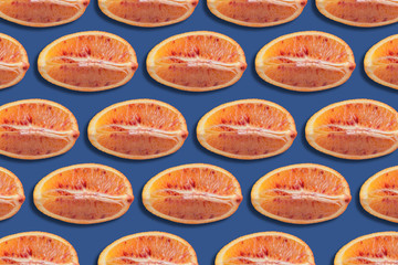 pattern of red orange slices on blue background, citrus background