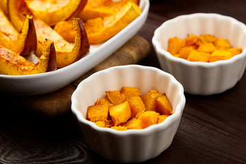 Slices of baked pumpkin in white ceramic bowl