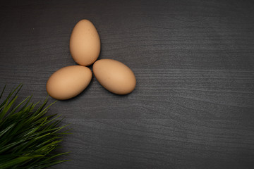 fresh eggs on dark wooden table