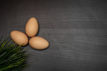 fresh eggs on dark wooden table