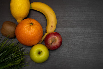 fresh fruit on dark wooden table representing healthy food