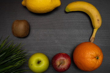 fresh fruit on dark wooden table representing healthy food