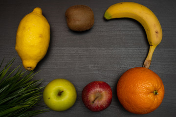 fresh fruit on dark wooden table representing healthy food