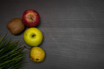 fresh fruit on dark wooden table representing healthy food