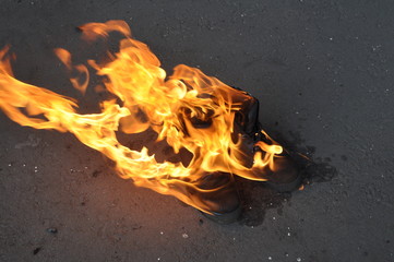 Burning shoes close-up. Burning work shoes shoes.