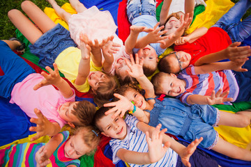 Little friends on a floor raising hands up