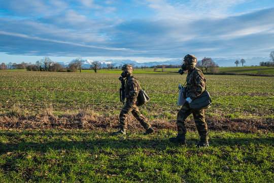 soldiers with gas masks during a simulation of conflict between soldiers and threats with fake corpses, fake threats and fake wounds during the training of French paratroopers