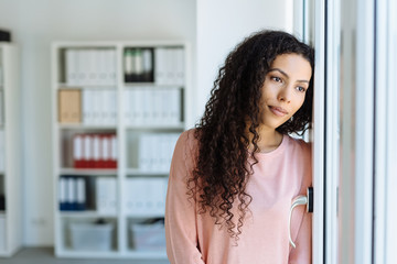 Young woman staring longingly through a window