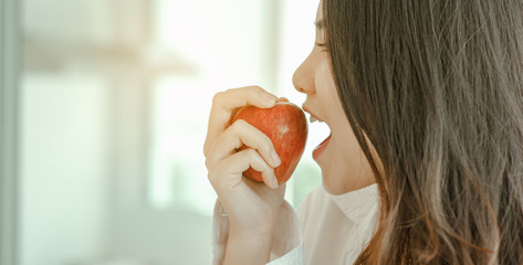 Young woman asia wake up refreshed in the morning and relaxing eat coffee, cornflakes, bread and apple for breakfast at house on holiday. Asian, asia, relax, breakfast, refresh, lifestyle concept. © Garun Studios